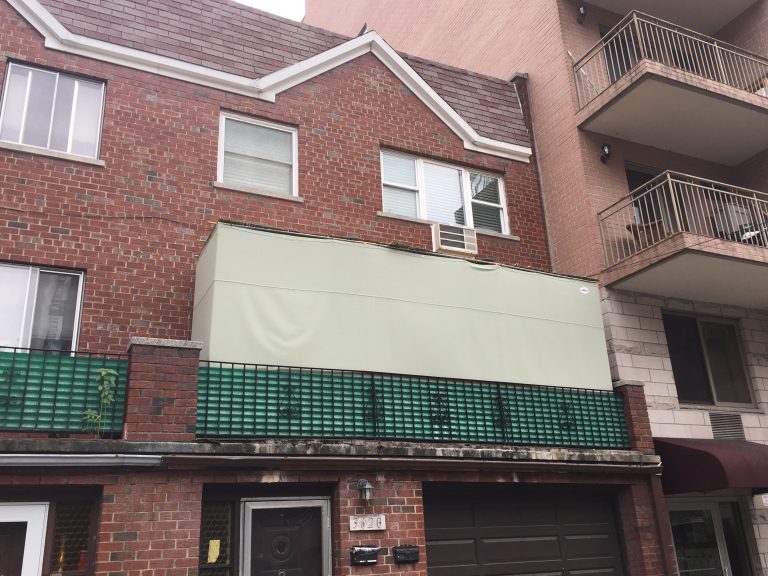 Custom sukkah kit set up on apartment balcony under open sky
