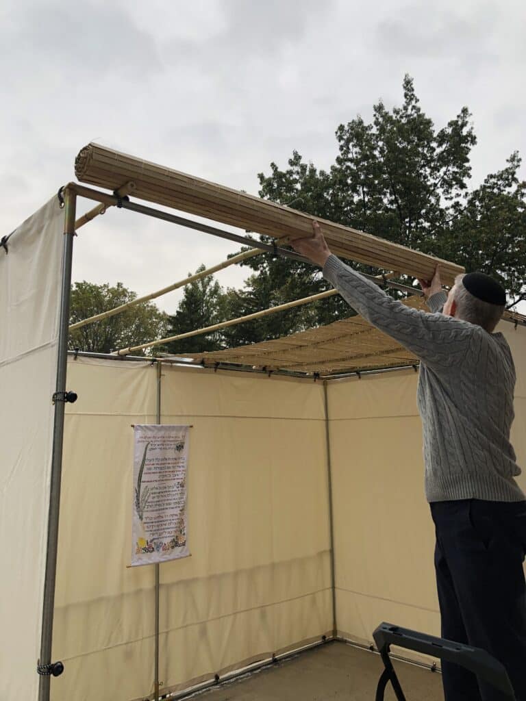 Family assembling a Sukkah Project sukkah kit without tools